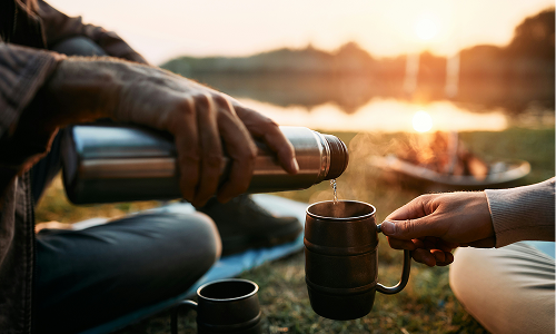 people pouring a drink outdoors