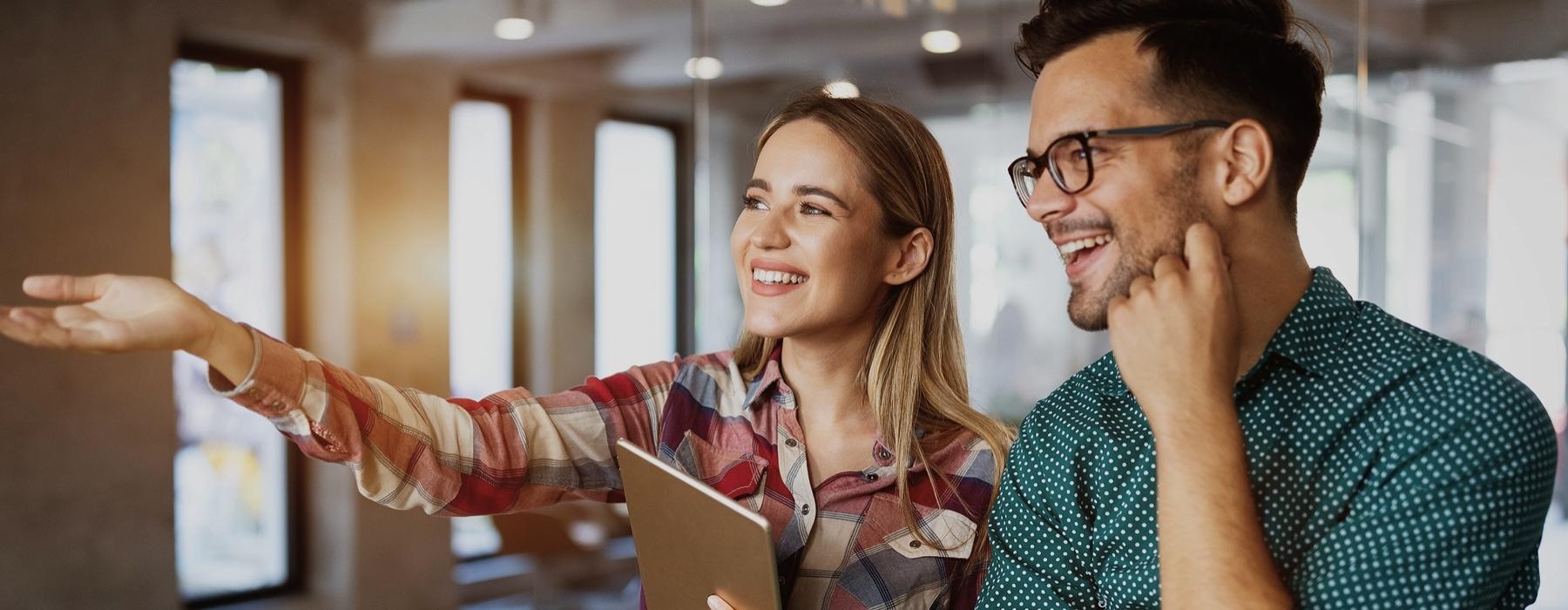 a man and a woman looking at a laptop