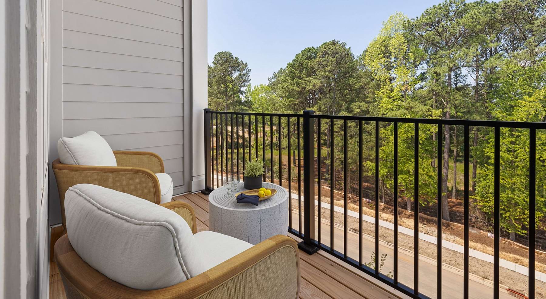 balcony with metal rail and chairs