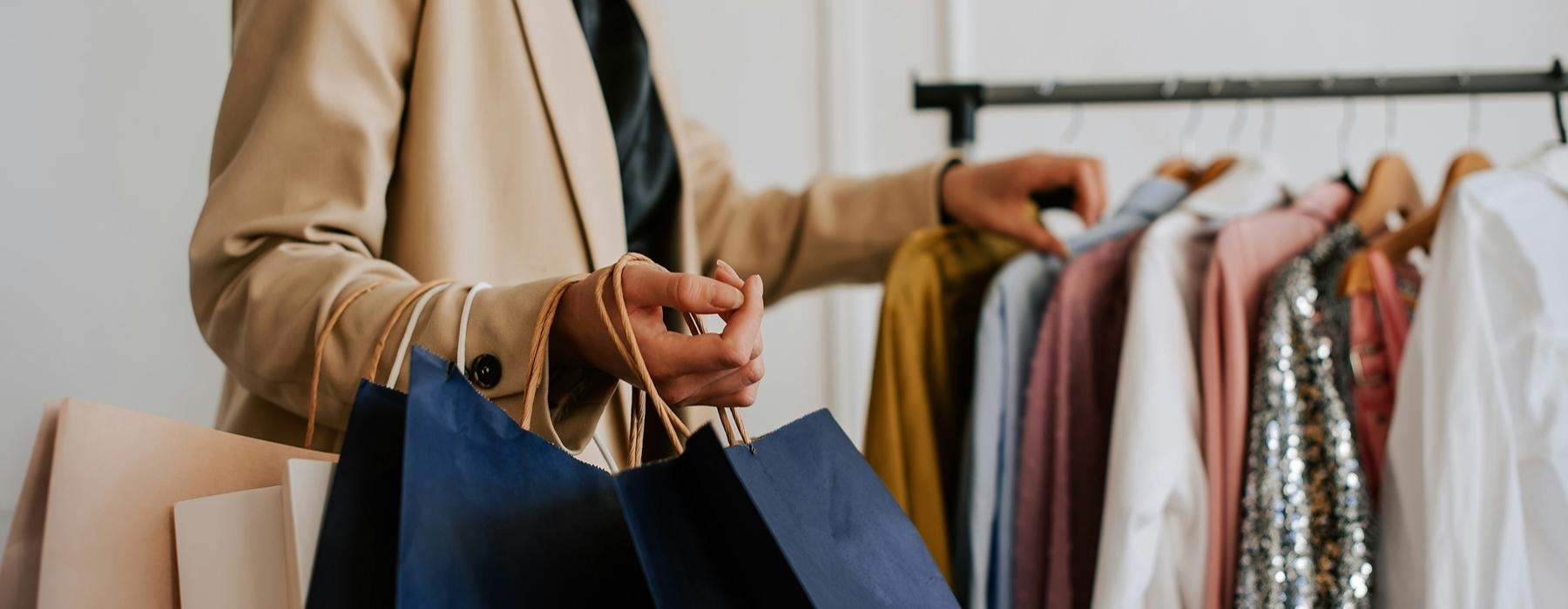 a person holding a bunch of clothes