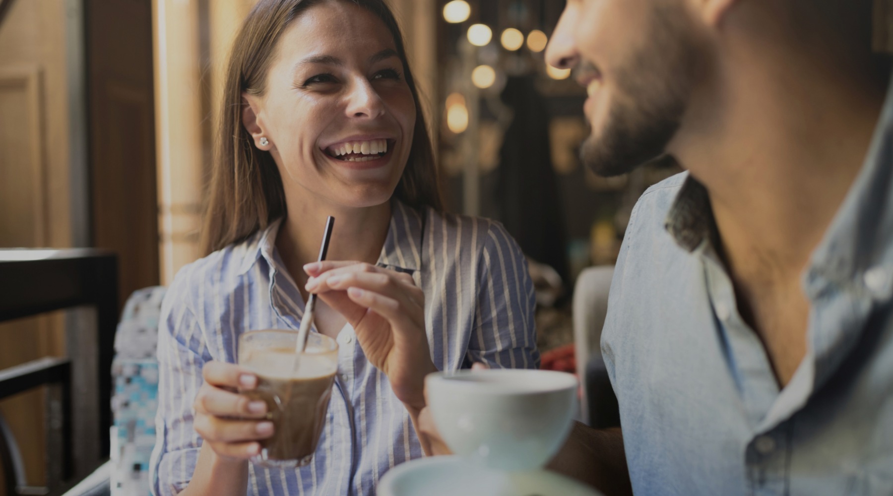a couple laughing with drinks